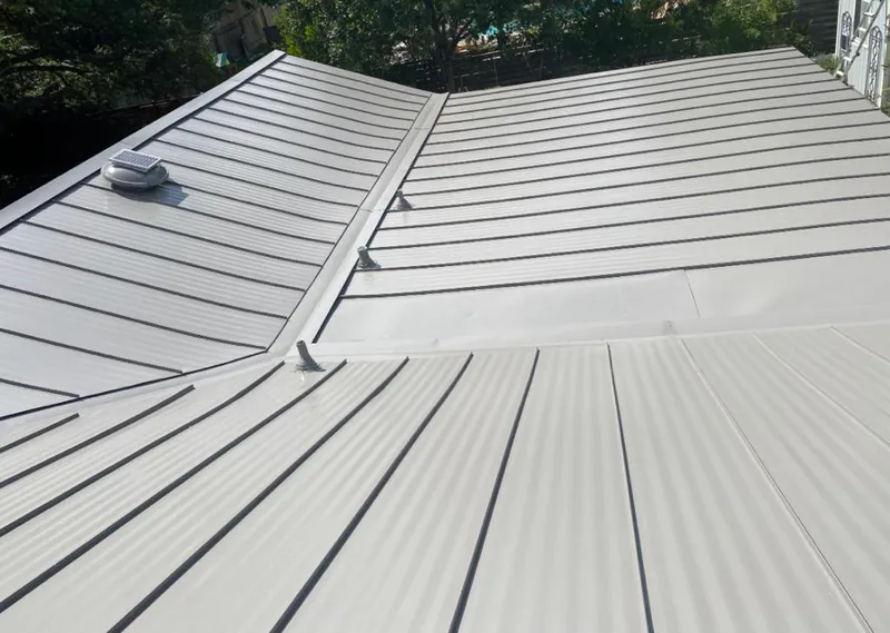 Solar attic fan installed on a metal roof for Roof Ventilation in Seagoville